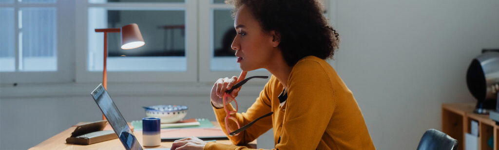 Vrouw die achter een scherm zit en vermoeide ogen heeft